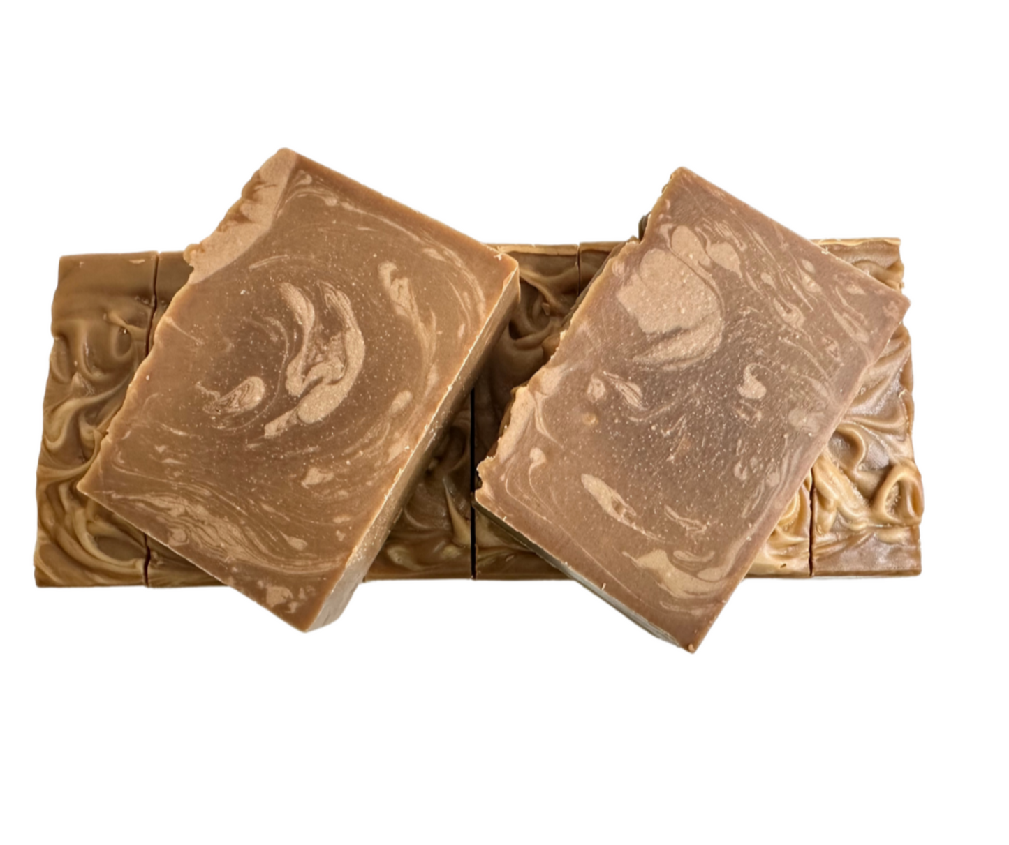 Two bar of soap over a log of sliced soap on a white background