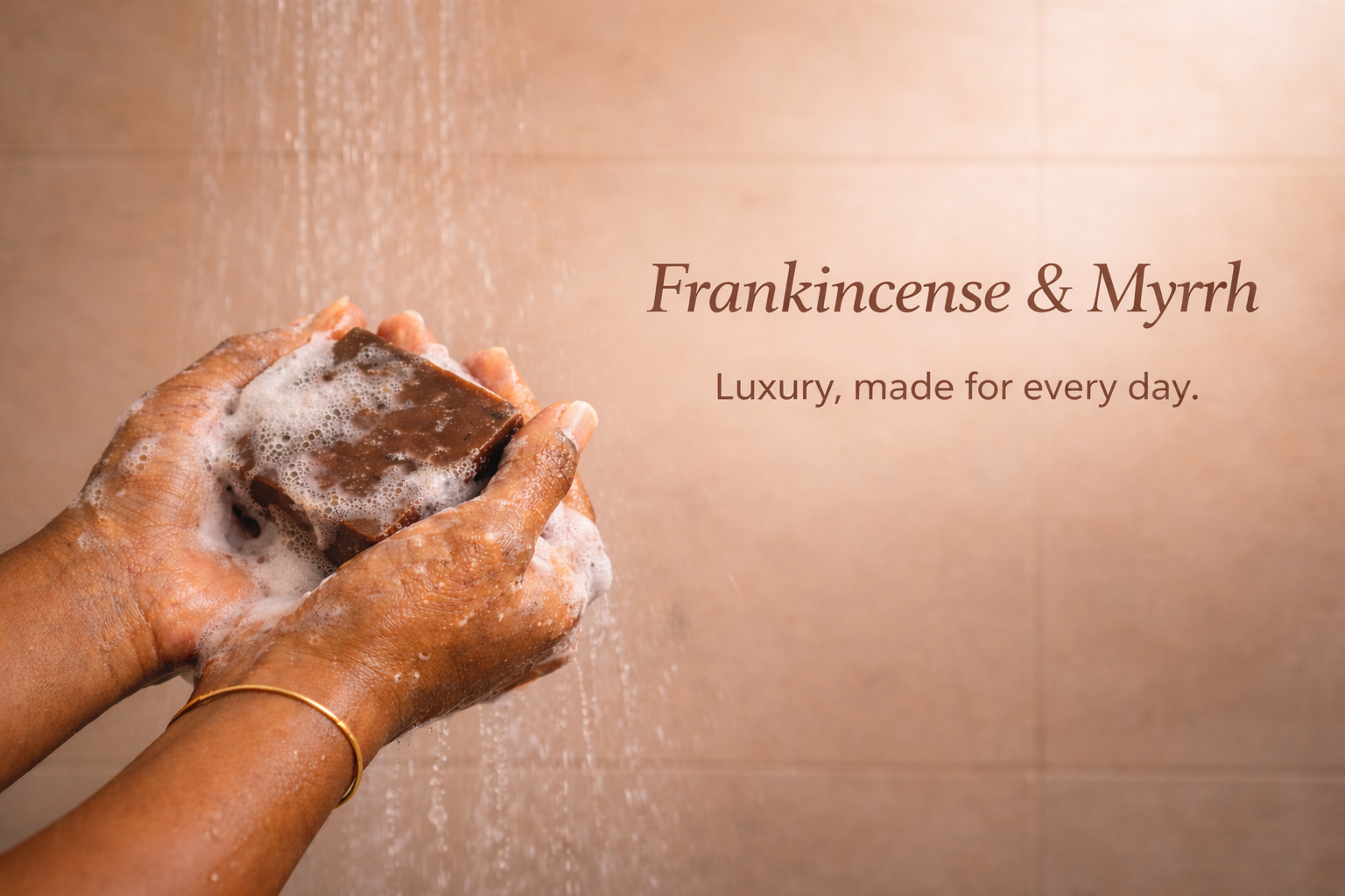 Hands holding a bar of soap under running water with 'Frankincense & Myrrh' Benyen Body Care Soap.