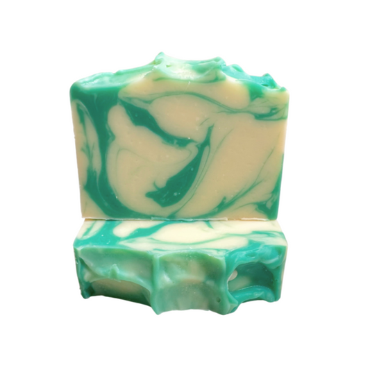 White soap with green swirls on white background with textured top