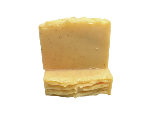 Two yellow soap bars stacked on a white background