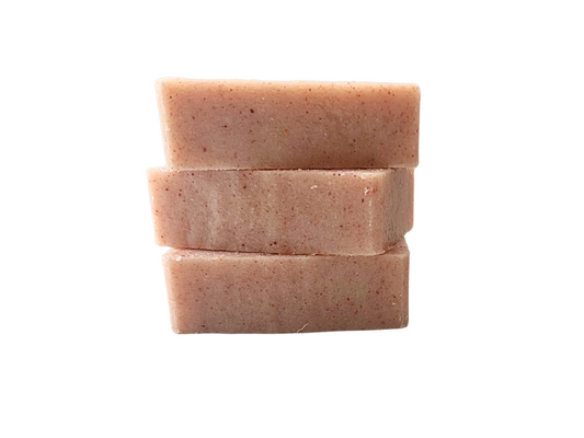 Stack of three pink sea salt oap bars on a white background